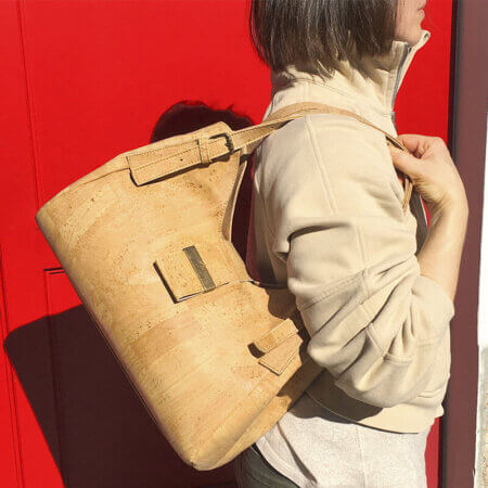 A woman with a handbag in natural cork